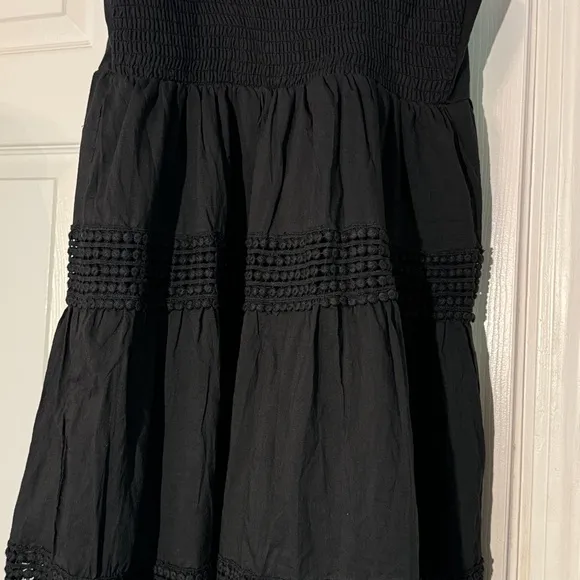 Black sundress fully lined with a smock backing and adjustable straps Size L NWT